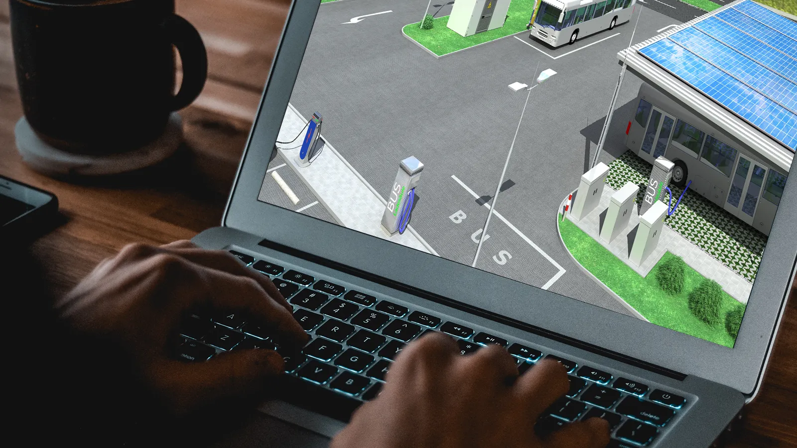 Laptop screen displaying a digital design of an electric bus charging station with solar panels.