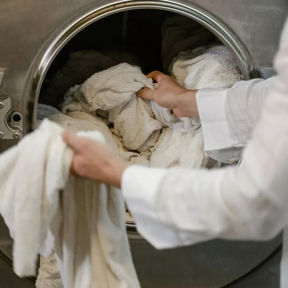 una lavatrice in fase di carico, attenzione alle muffe e agli odori che potrebbero rovinare il bucato